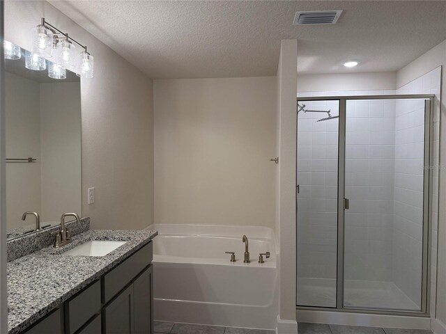 bathroom featuring a garden tub, a stall shower, and tile patterned flooring