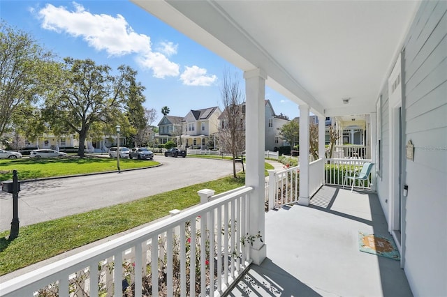 balcony featuring a residential view and a porch