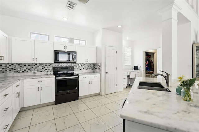 kitchen with visible vents, black appliances, marble finish floor, white cabinetry, and a sink