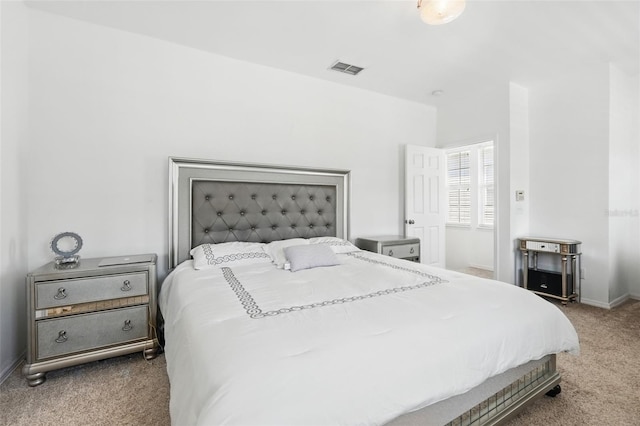 bedroom with visible vents, baseboards, and carpet