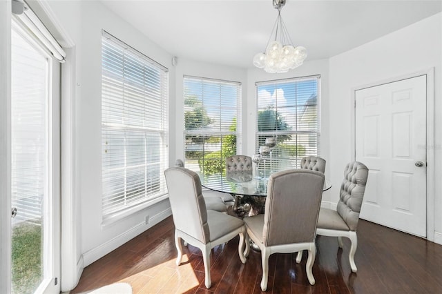 dining space featuring a notable chandelier, wood finished floors, and baseboards