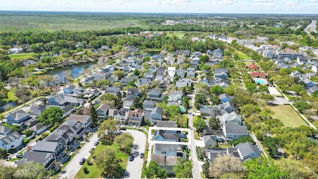 drone / aerial view featuring a residential view and a water view