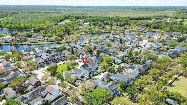 bird's eye view with a residential view, a water view, and a view of trees