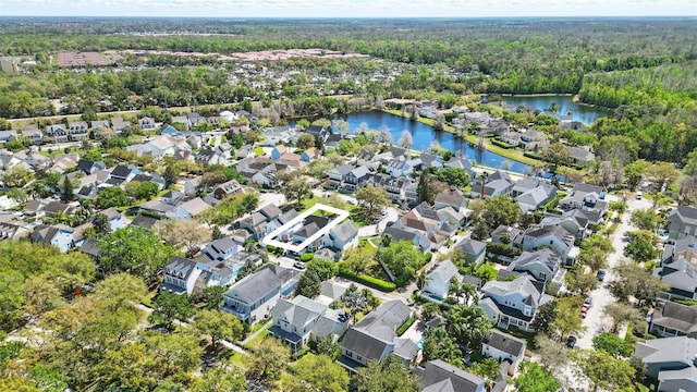 bird's eye view with a residential view, a view of trees, and a water view