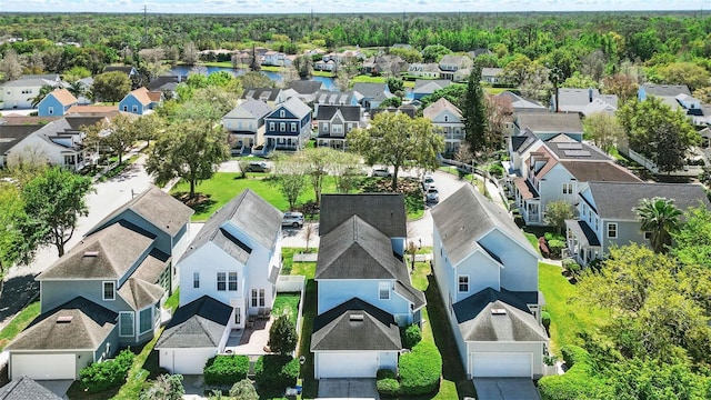 drone / aerial view with a residential view and a water view