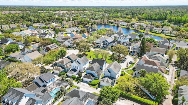 bird's eye view featuring a residential view, a view of trees, and a water view