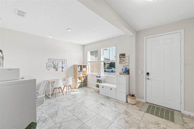 foyer entrance featuring washer / dryer, visible vents, marble finish floor, and baseboards