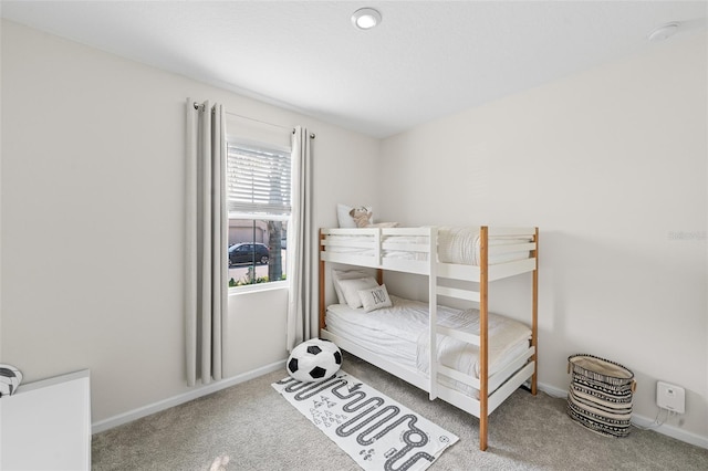 bedroom featuring carpet flooring and baseboards