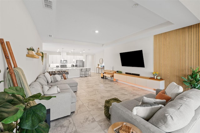 living room featuring recessed lighting, visible vents, and marble finish floor