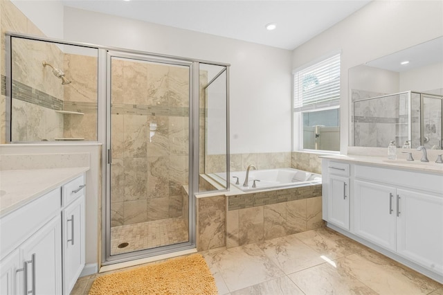 bathroom featuring a bath, a shower stall, and vanity