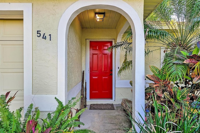 property entrance featuring stucco siding