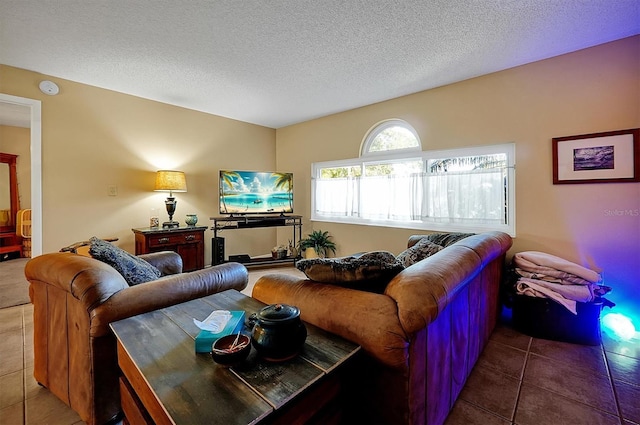 tiled living area featuring a textured ceiling