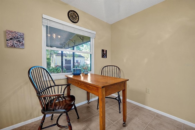 office area featuring tile patterned floors, baseboards, and a textured ceiling