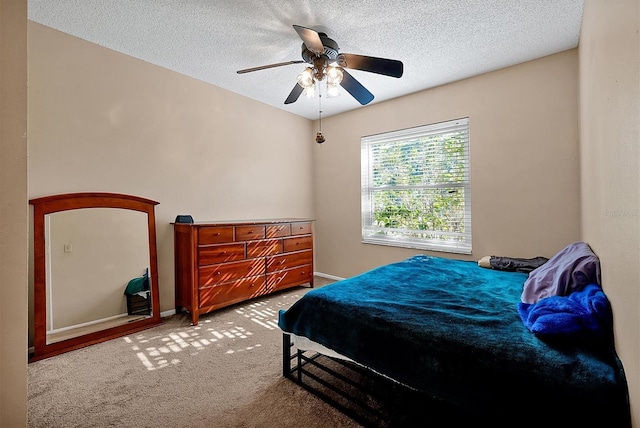 bedroom featuring baseboards, carpet flooring, a textured ceiling, and ceiling fan