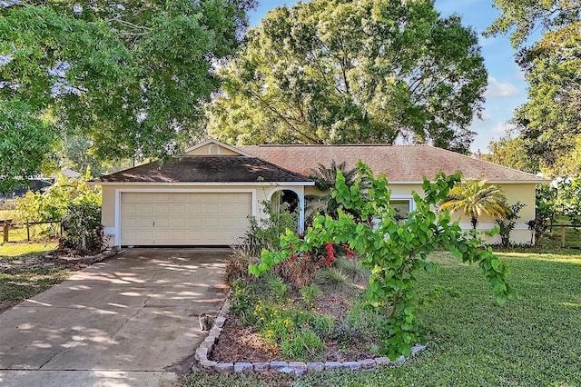 single story home featuring a front yard, fence, driveway, stucco siding, and a garage