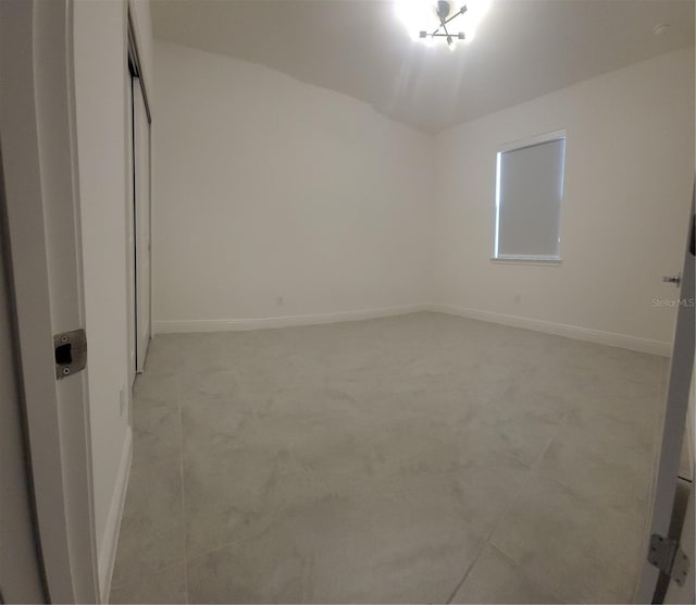 unfurnished bedroom with baseboards, light carpet, and a closet