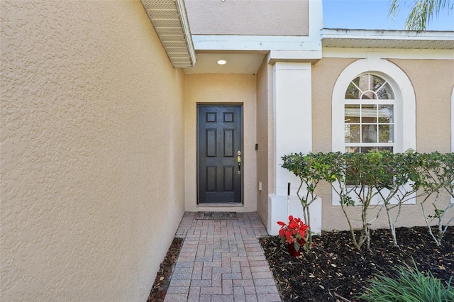 doorway to property with stucco siding