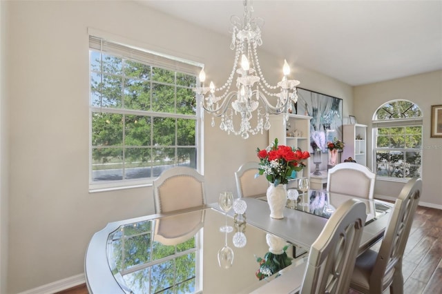 dining area with a notable chandelier, wood finished floors, and baseboards