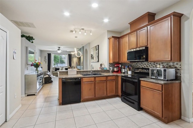 kitchen featuring brown cabinetry, visible vents, a sink, black appliances, and open floor plan