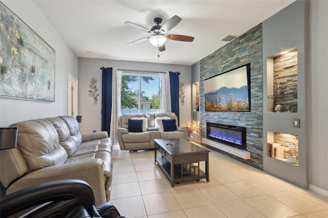 living area featuring light tile patterned floors, a fireplace, visible vents, and ceiling fan