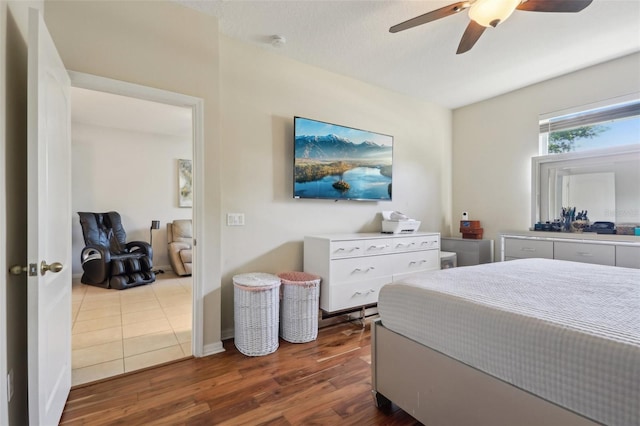 bedroom featuring wood finished floors, baseboards, and ceiling fan