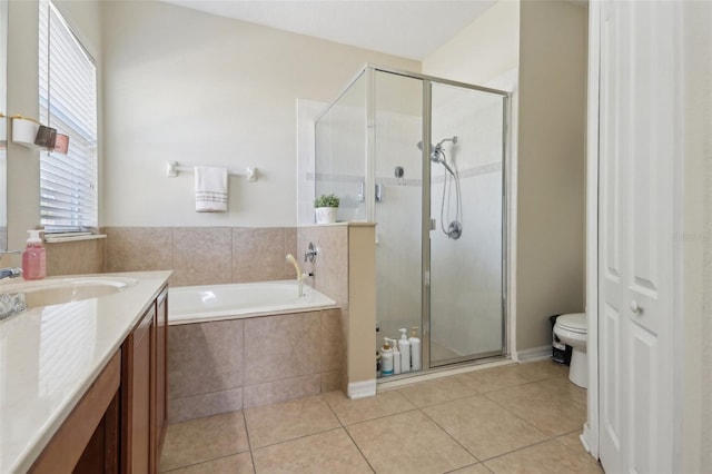 full bath with toilet, a shower stall, tile patterned flooring, a bath, and vanity