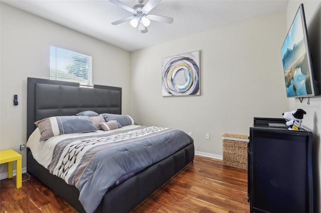 bedroom featuring a ceiling fan, wood finished floors, and baseboards