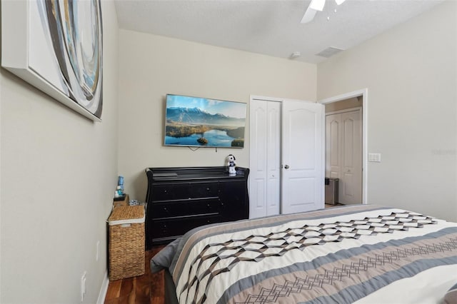 bedroom featuring visible vents, baseboards, ceiling fan, wood finished floors, and a closet