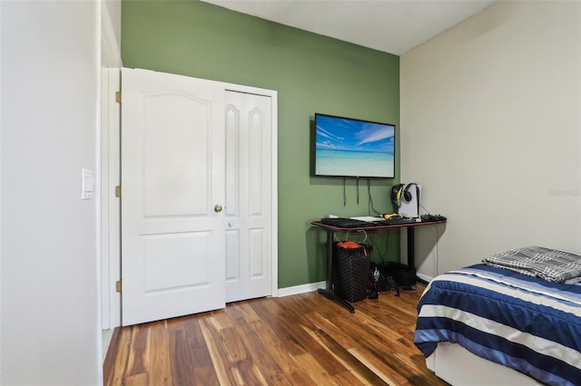 bedroom with baseboards and wood finished floors