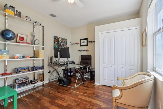 office with baseboards, wood finished floors, visible vents, and ceiling fan