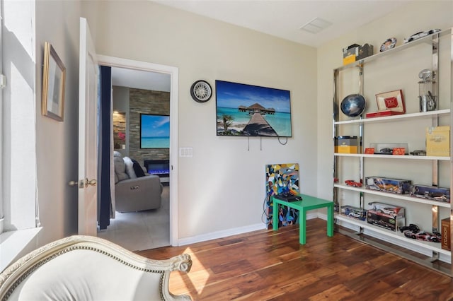 game room with baseboards and wood finished floors