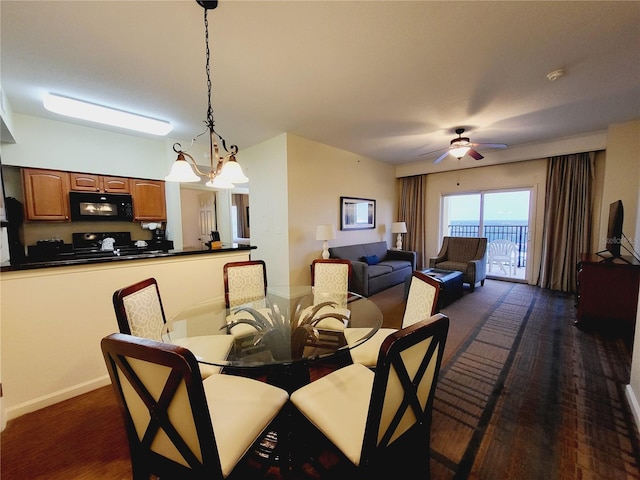 dining space with ceiling fan with notable chandelier