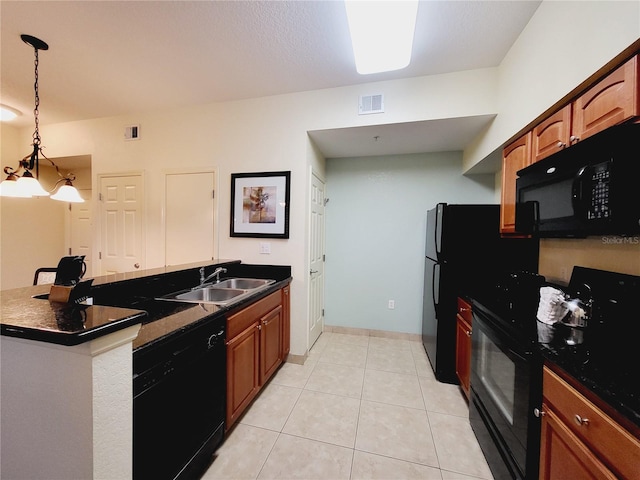 kitchen with visible vents, light tile patterned flooring, a sink, black appliances, and dark countertops