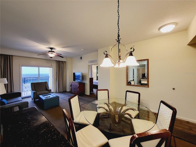 dining area featuring baseboards, dark wood finished floors, and a ceiling fan