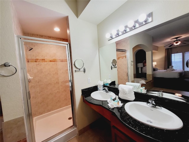 ensuite bathroom with ensuite bath, a shower stall, and a sink