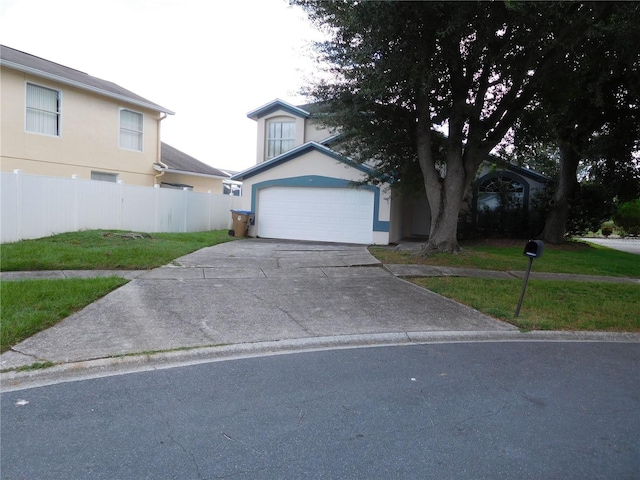 view of front of home featuring fence, driveway, stucco siding, a front lawn, and a garage