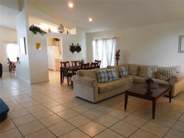 living room featuring lofted ceiling, light tile patterned floors, recessed lighting, and baseboards