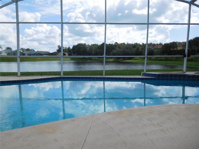 outdoor pool featuring a lanai and a water view