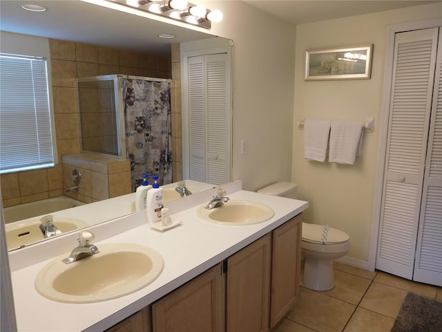 bathroom featuring tile patterned floors, toilet, a closet, and a sink