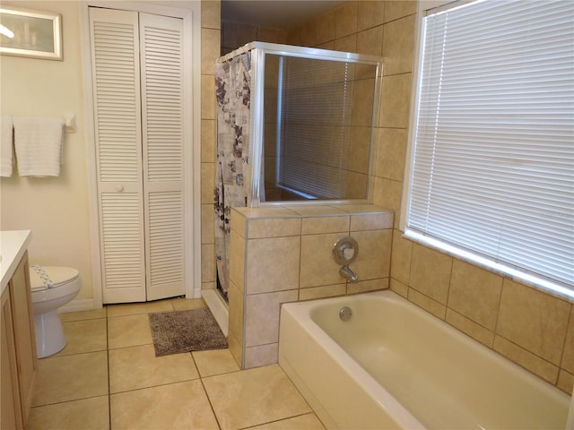 full bathroom featuring a closet, a shower stall, vanity, and tile patterned flooring