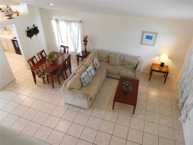 living area featuring light tile patterned floors and baseboards