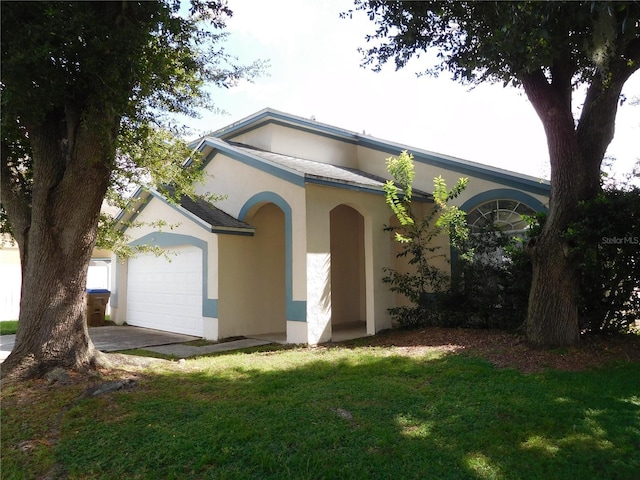 ranch-style home with a front yard, a garage, and stucco siding