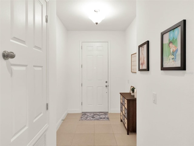 foyer featuring light tile patterned floors and baseboards