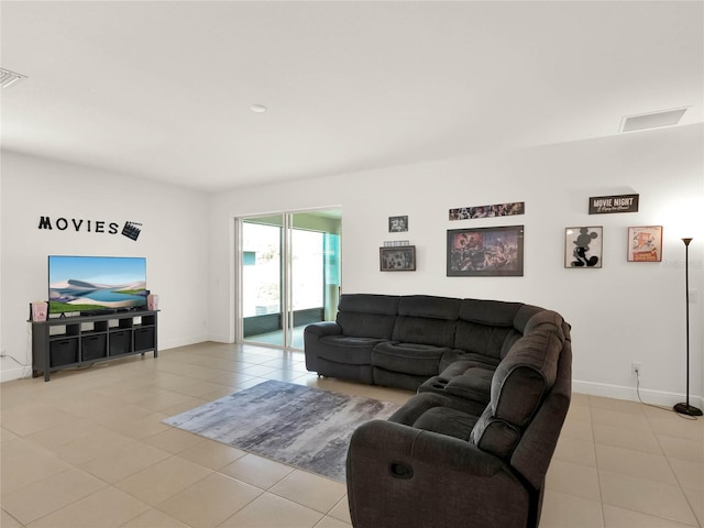 living room with light tile patterned floors and baseboards