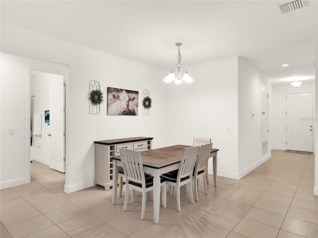 dining area featuring an inviting chandelier, light tile patterned floors, baseboards, and visible vents