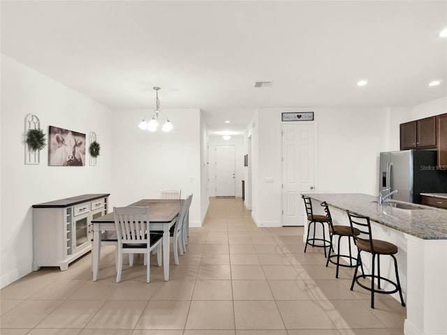 dining space featuring visible vents, a notable chandelier, recessed lighting, light tile patterned floors, and baseboards