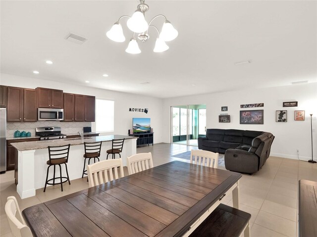 dining space featuring recessed lighting, visible vents, plenty of natural light, and a notable chandelier