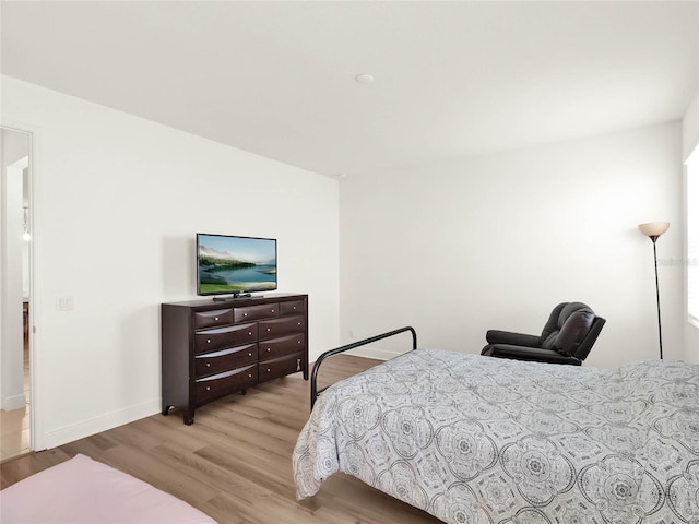 bedroom with wood finished floors and baseboards