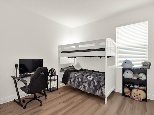 bedroom with wood finished floors and baseboards