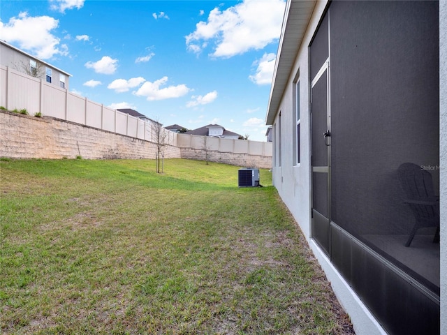 view of yard with cooling unit and a fenced backyard